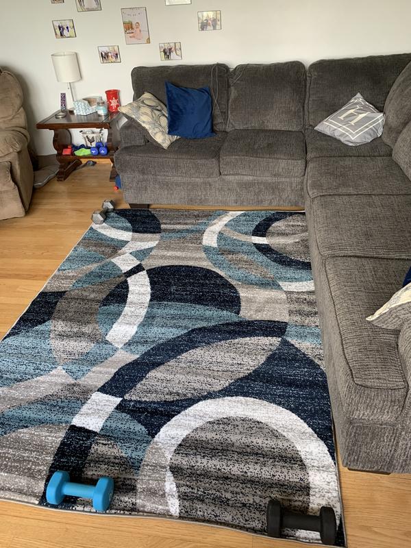 Rug laid out. Ignore the weights, just trying to get it to lay flat