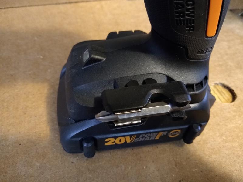 This is the WX102L drill with an aftermarket bit holder installed using one of the existing belt clip threaded inserts. It does not interfere with the battery or get in the way.
