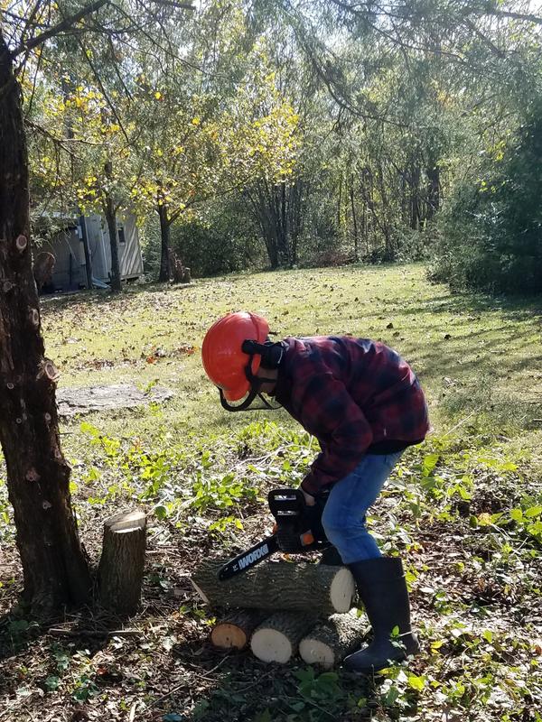 Cooper cutting up logs for the fire.