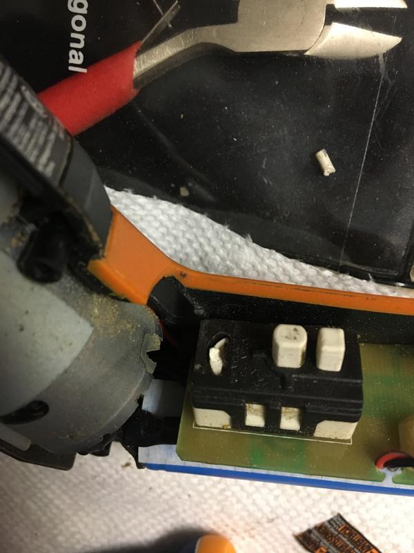 Switchattached to motherboard in lower half, broken white pin on black background.