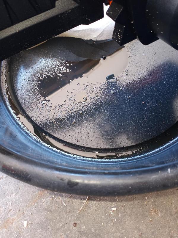 Saw dripping into an oil drip pan.