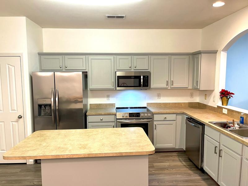 Kitchen cabinets after they were refinished and painted with the Worx Cordless Paint Sprayer