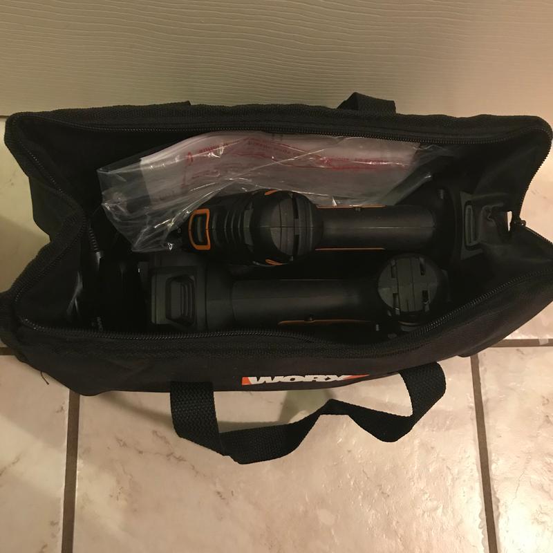 Both drills with batteries attached, manuals, and charger