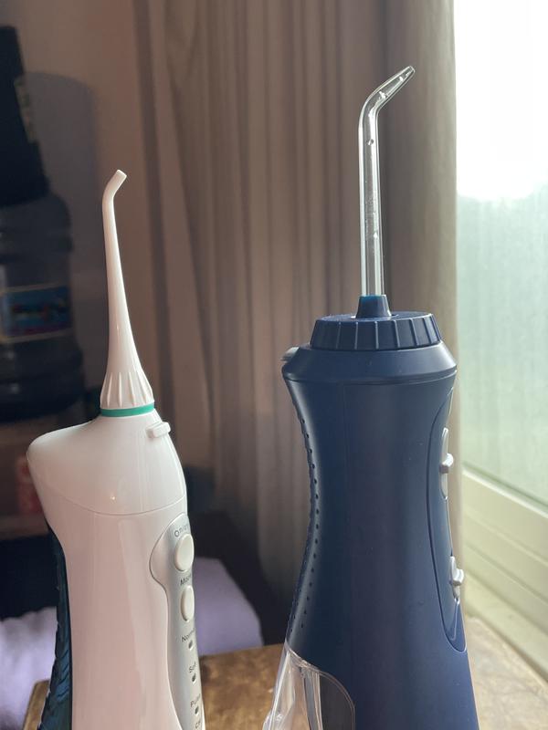 With the Water Pik on the right, you can see how because its pik is in the center of the holder, the pik on the left has a farther reach. The thickness of the holder on the right is also harder to hold if you have small hands or arthritic fingers/hands.