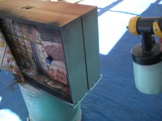 Spraying sides of drawers with Detail Finish gun