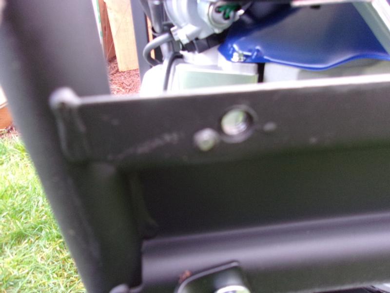 gray area to the left of the bolt hole is a piece of welding slag