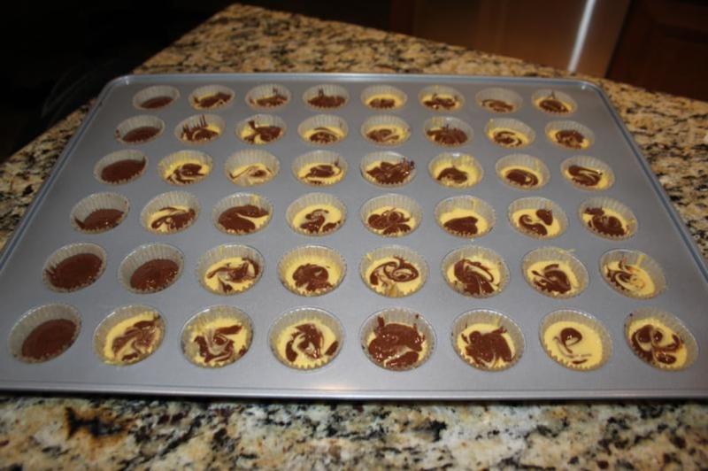 Filled parchment liners a little over half full. Marble mini cupcakes.