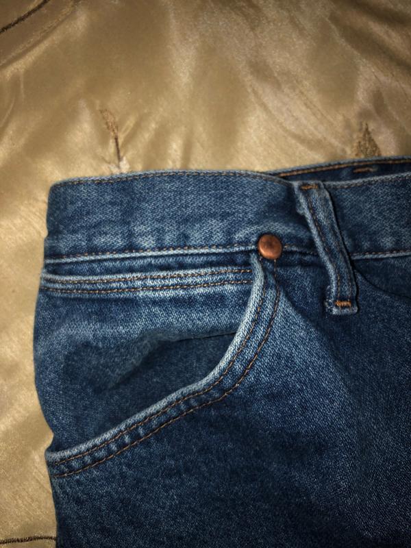 In this image, looking at the belt loop and the opening to the pocket watch pocket you can see that the opening lies directly under the belt.