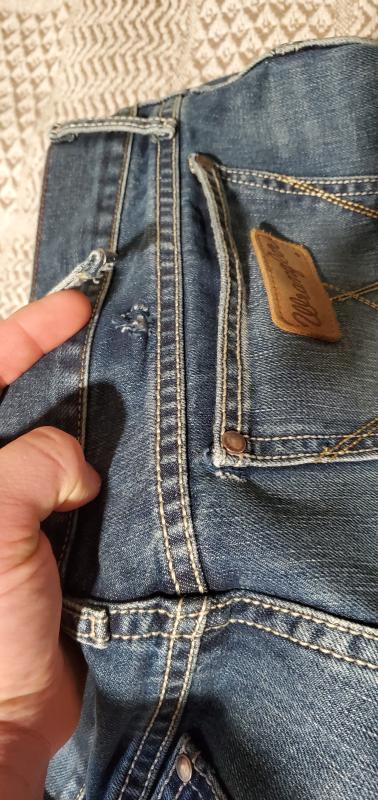 Belt loop and  pocket corner tear.