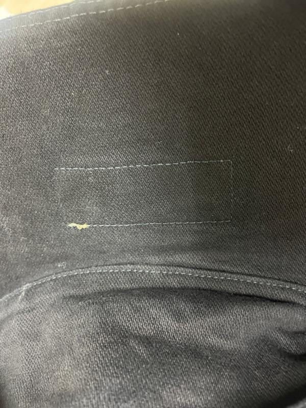 sticking on the label showing on the back of the jacket looks sloppy