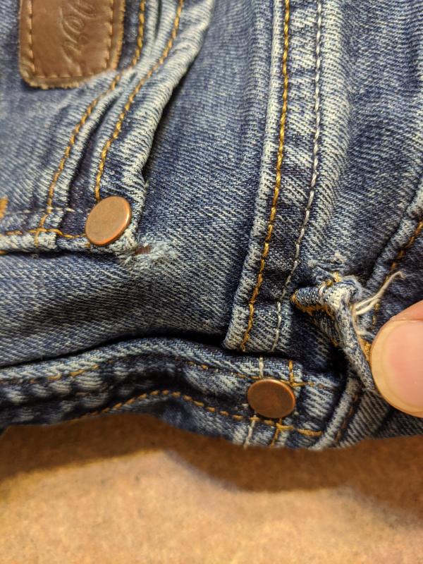 Hole above pocket and belt loop tearing off. The belt loop on the opposite side looks the same.