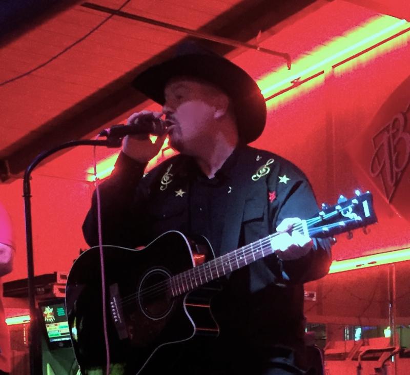 Thad Foster singing is his Wrangler custom designed shirt.