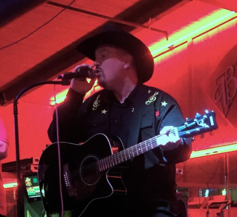 Thad Foster singing is his Wrangler custom designed shirt.