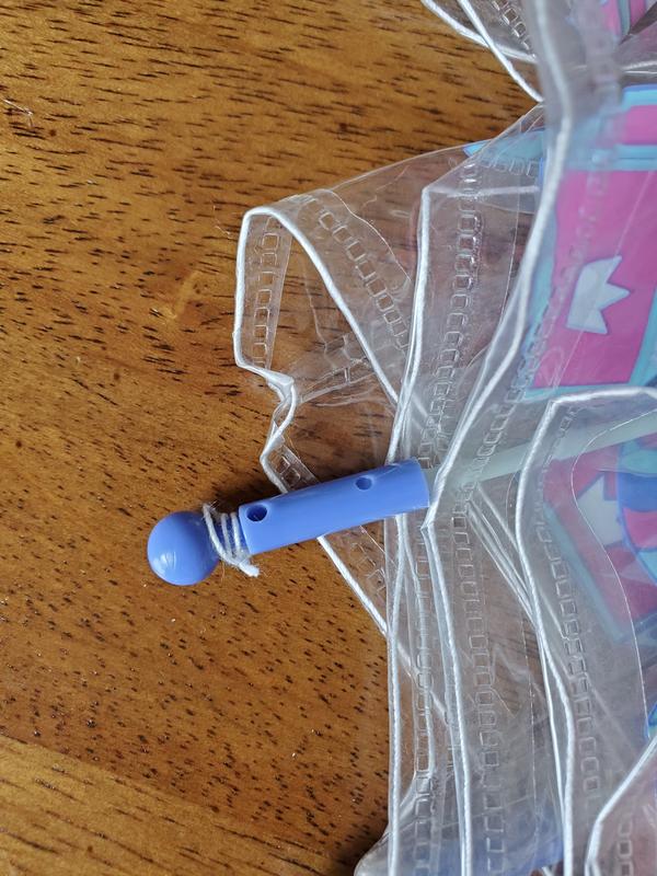 The tiny flap in the plastic is how it's tied on to the umbrella spoke. The string does not run through a hole in the spoke or in the plastic. There is a string that runs underneath the flap and then around the spoke.