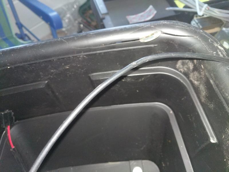 Cracked corner and bent cable. Washer added only to show crack better