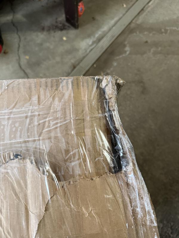 Taped up, dented box.