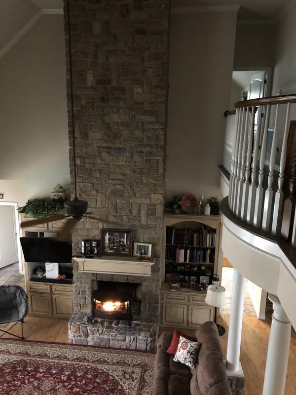 Ceiling fan set backwards circulates heat air effectively.