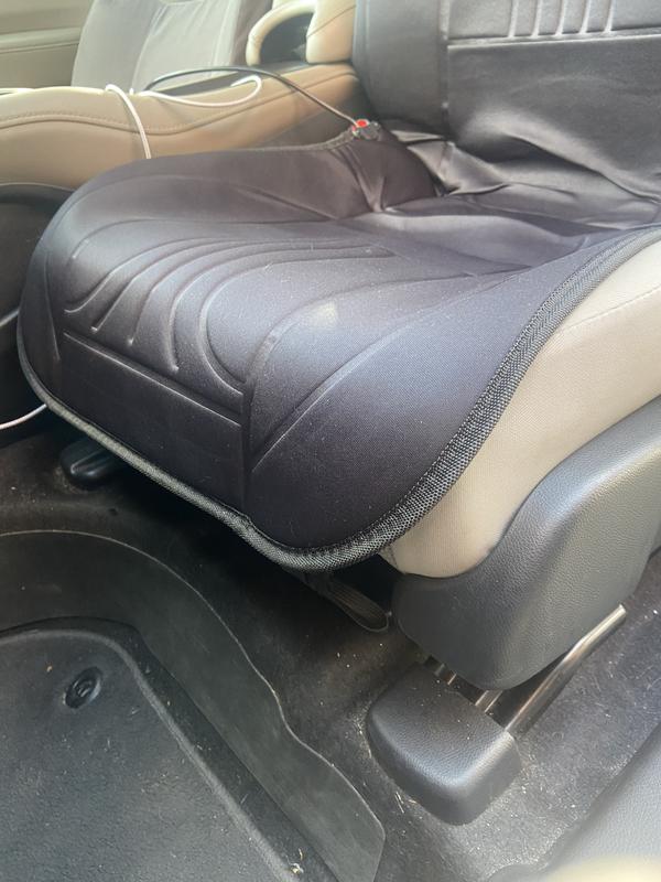 In an SUV the cover extends to cover front portion of seat, preventing it from sliding