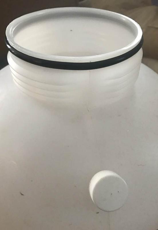 Black o-ring at top.  Cap that is stored at top until you need to fill with water, then put on bottom water spout.