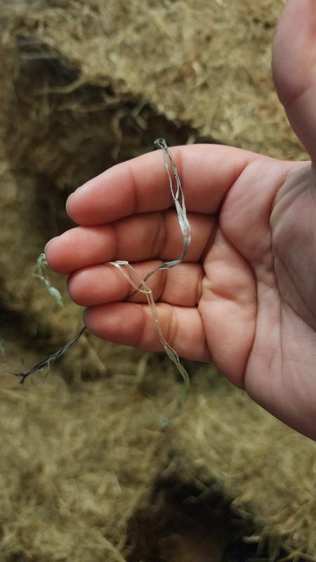 Hay netting chopped up in hay bales