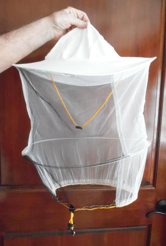Veil has a chin strap to hold in place and drawstring at the base to keep out bugs.  Plenty of room to move your head around inside the veil - it doesn't touch your face.