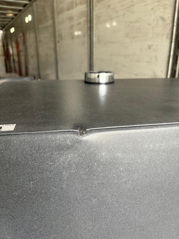 Back Panel - dent.  Back view of keypad resting on top of Safe