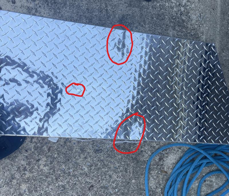 Two large "fold" dents on the lid.  Peppered with small dents on top.