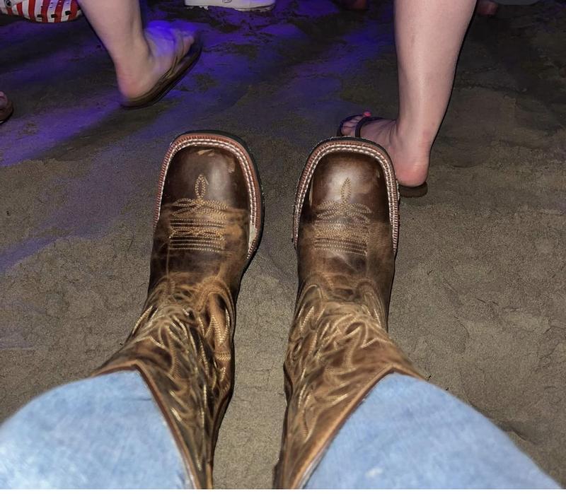 Admiring my cool boots and taking a break between acts at the festival