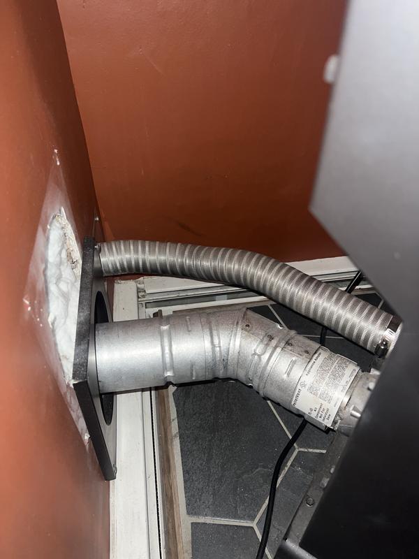 Exhaust is straight out side after a single 45 elbow I had to raise the stove up 7” to be able to exhaust it perfectly