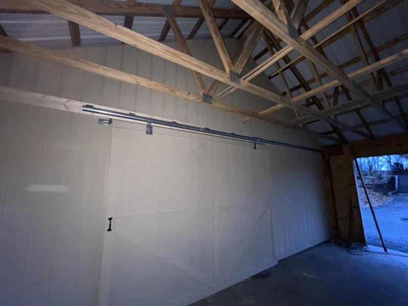 The door weights about 300 lbs. I used 2 rollers about 7’ apart. Balance is perfect