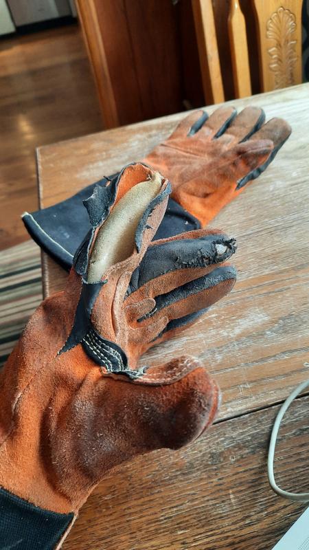 JOBSMART glove after less than one month of use loading wood into a wood stove.