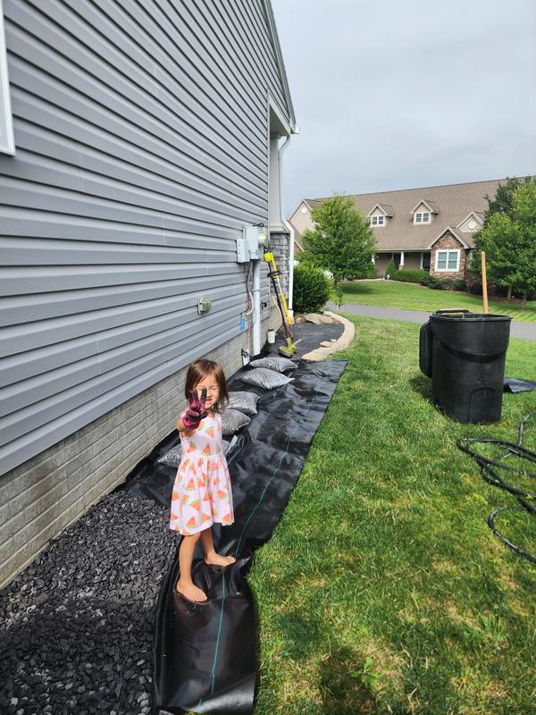 Laying the Sealtech with my trusty 3.5 yr old to cover weeds on side of house and lay down paver rock for clean look, thank you TSC!