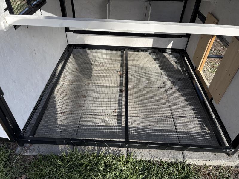 Hardware cloth installed under coop.  Modified door opening visible