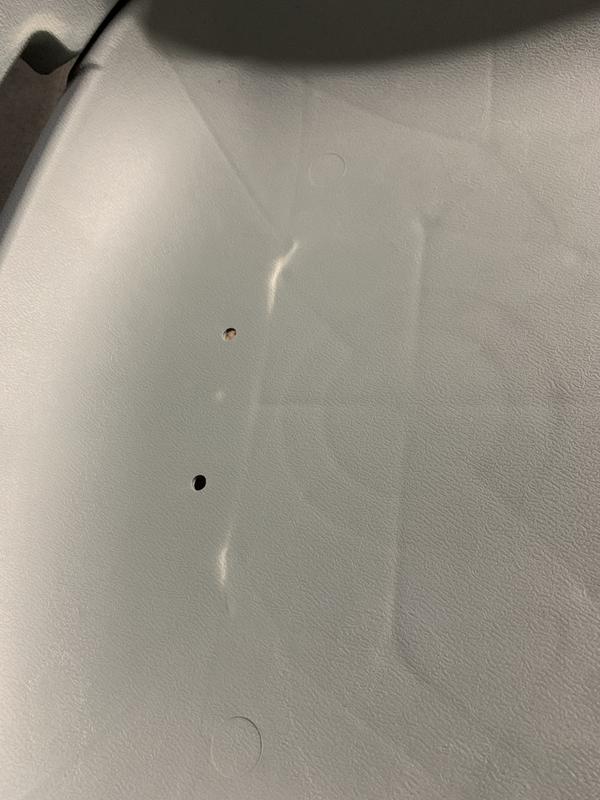 Metal brace pushing through the plastic seat bottom