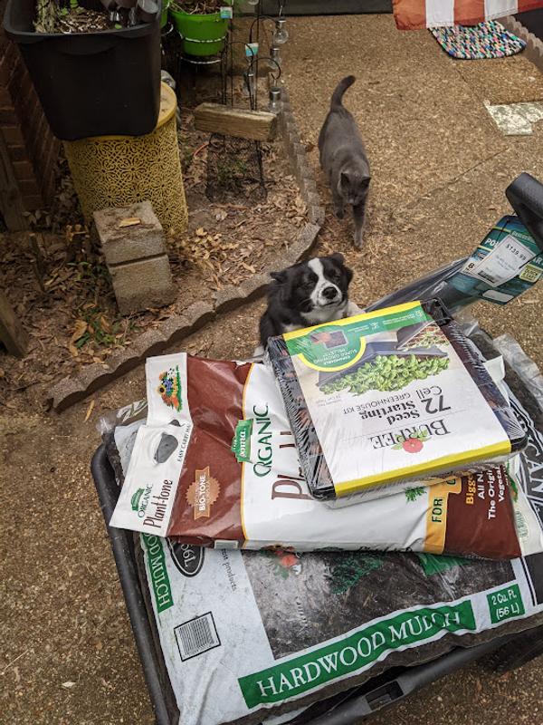 3 bags of 2 cubic feet mulch, 1 18 pound bag of fertilizer, 1 package of seed cells, and a weed barrier all in one load.