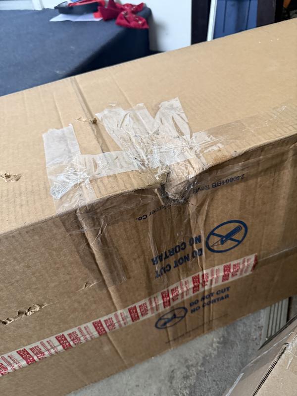 Taped up, dented box.