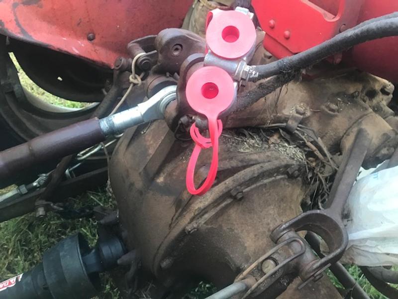 USA made hydraulic end covers(red) on MF-135 tractor (unconnected but protected)