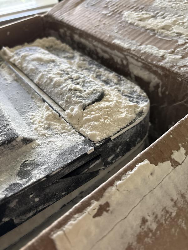 Cracked lid with powder everywhere