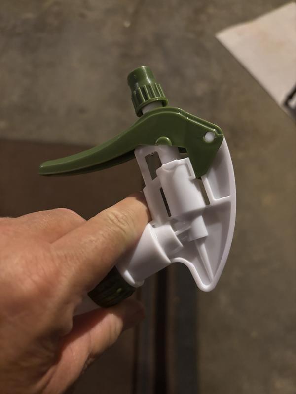 Handle design makes it impossible to hold and operate the bottle comfortably.