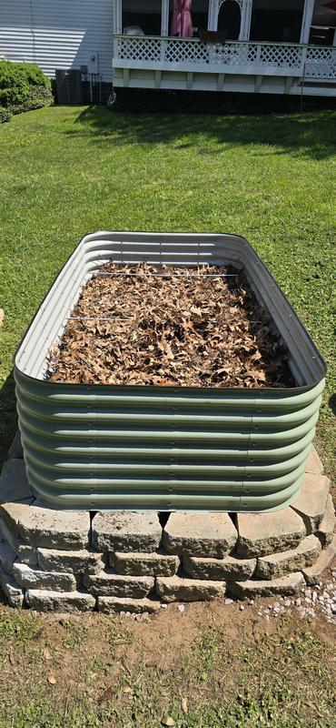Sloping yard required landscaping rocks. Filled 1/2 way with old logs and leaves. Then finished off with garden soil-mushroom compost. Didn't take garden soil picture, sorry