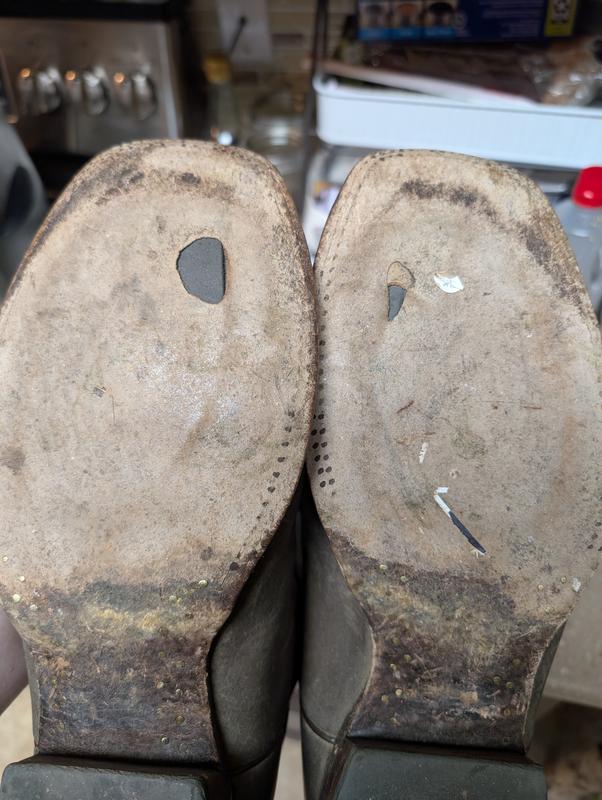 Holes worn at base of big toe area in both shoes