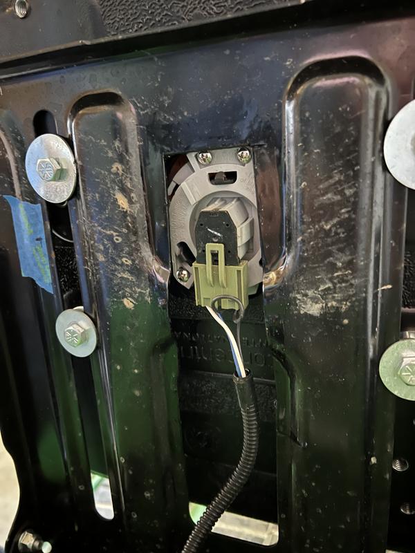 See the screws in the 'wings' of the switch to mount it to the seat, the additional seat frame cutout for the switch, and the removal of the seat adjust sliders and washers to fit the hole pattern.