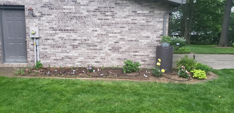 The rain barrel will provide water to our new flower bed!