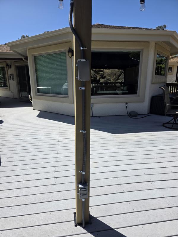 Waterproof GFI protected Electrical run from house, beneath deck and up post for center fan and string lights.