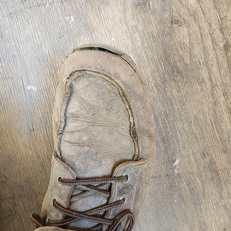 Glue came loose. Needs a thread running thru toe material and rubber sole to hold together