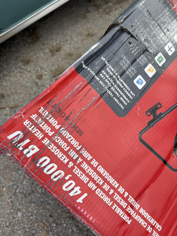 Damaged shipping carton appeared to be by a fork lift.