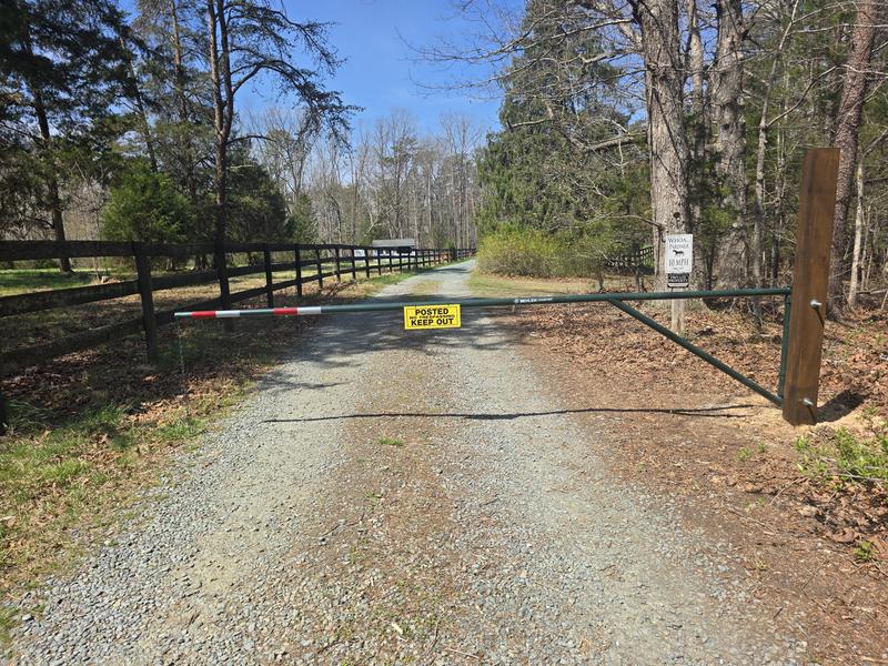 Gate extends across driveway just to neighbor's property line.