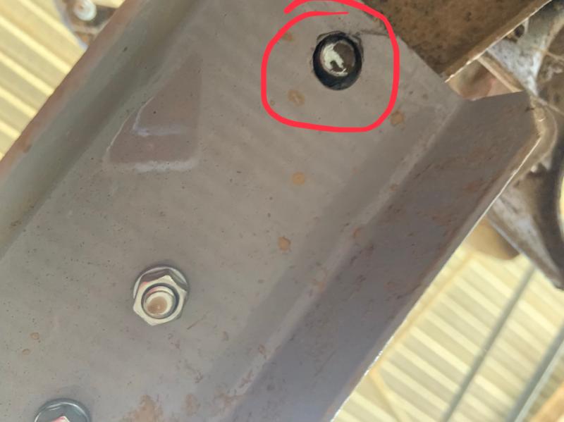 When the bracket bends up it moves the pin up out of the hole