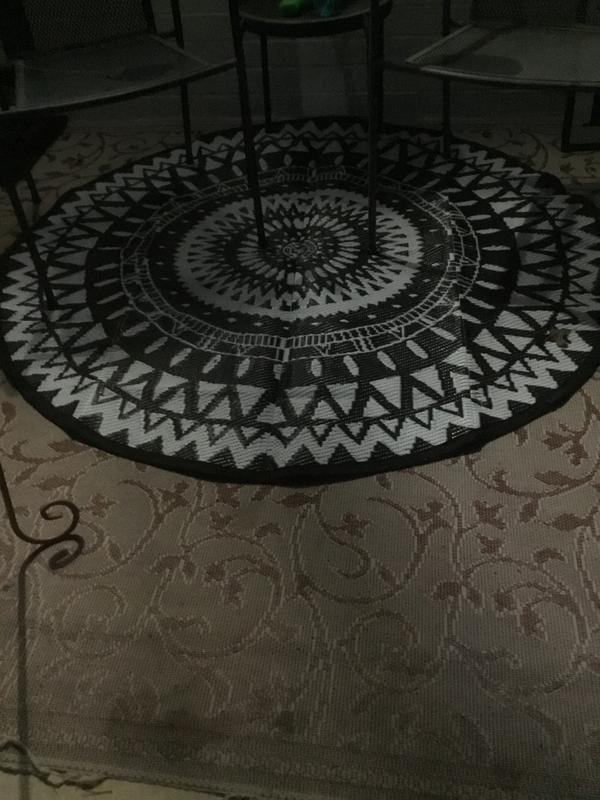 Edges curled, trying to use chairs to hold it down.