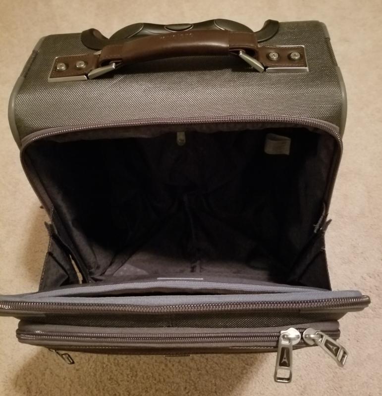 Bag unzipped, with velcro and snap engaged to keep bag from opening completely.